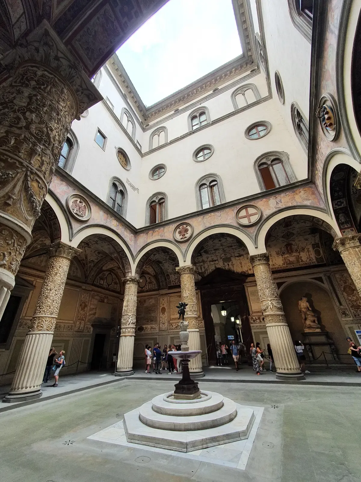 The arcaded first courtyard of Palazzo Vecchio with its fountain, seen on a Florence in one day tour from Rome